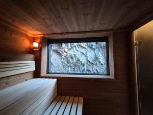 a room with a sauna with a window at Logis Hôtel Restaurant De La Poste et SPA de Montagne in Le Bonhomme