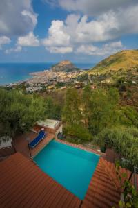 a swimming pool on top of a house with a view of the ocean at L' Arca Residence in Cefalù