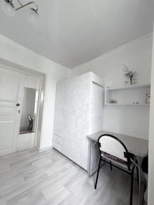 a white room with a table and a chair at Mountain View Guest House in Zhabagly