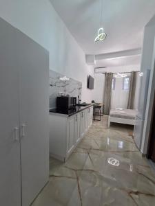 a kitchen with white cabinets and a counter top at Fabian Studio in Tulcea