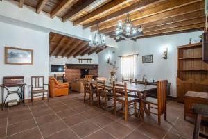 a dining room with a table and chairs and a fireplace at Casa dos Avós in Mértola