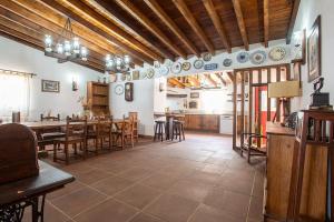 a large dining room with a table and chairs at Casa dos Avós in Mértola