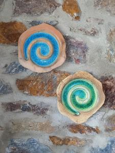 two stone spirals are sitting on a stone floor at il mare stone house with Aegean view in Agios Dimitrios