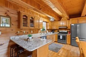 a large kitchen with wooden cabinets and a large island at Oh Deer in Morganton