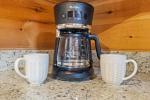 a coffee maker and two cups on a counter at Oh Deer in Morganton