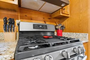 a stove top oven in a kitchen with wooden cabinets at Oh Deer in Morganton