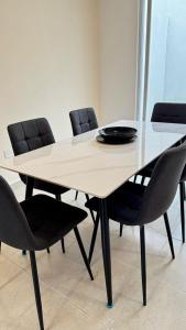 a table with chairs and a plate on top of it at Casa completa y equipada in Saucillo de la Joya