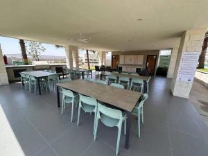 a dining room with tables and chairs in a building at Casa completa y equipada in Saucillo de la Joya