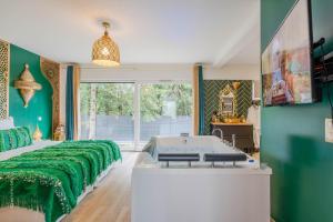 a bedroom with a bed and a tub in it at Suite Riad Luxe avec jacuzzi proche Disney in Nanteuil-lès-Meaux