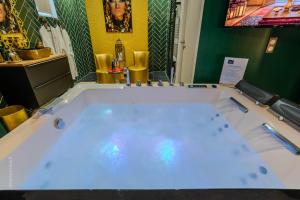 a large tub in a bathroom with at Suite Riad Luxe avec jacuzzi proche Disney in Nanteuil-lès-Meaux +33 photos