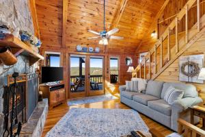 a living room with a couch and a fireplace at Peaks & Pines in Morganton