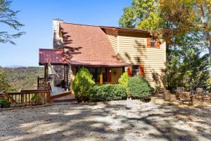a wooden house with a porch and a fence at Peaks & Pines in Morganton