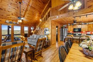 a dining room and kitchen in a cabin with wooden walls at Peaks & Pines in Morganton +48 photos