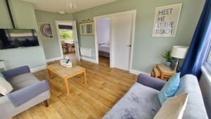 a living room with a couch and a table at 3 The Burrows in Braunton