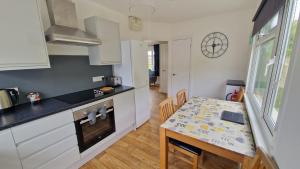 a kitchen with a table and a dining room at 3 The Burrows in Braunton
