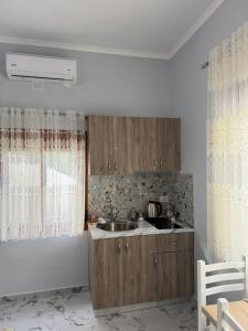 a kitchen with a sink and a counter top at Mesaiz in Vlorë