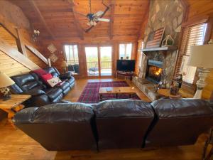 a living room with leather furniture and a fireplace at RendezView in Morganton