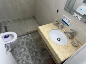 a bathroom with a sink and a toilet at Studio complex Miramare Nord in Năvodari