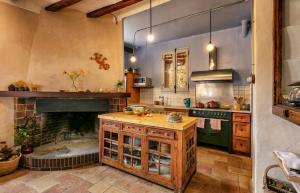 a kitchen with a fireplace and a counter in front of it at Cal Compte in Torroja