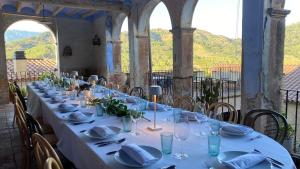 a long table with plates and napkins on it at Cal Compte in Torroja