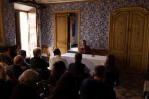 a group of people sitting around a table in a room at Cal Compte in Torroja