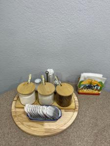a wooden tray with three sinks and towels on it at Downtown Homestay in Bishkek