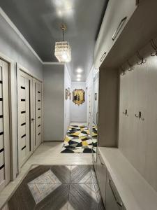 a hallway with a rug on the floor at Downtown Homestay in Bishkek