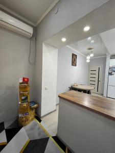 a kitchen with a counter and a table in a room at Downtown Homestay in Bishkek