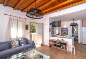 a living room with a blue couch and a table at Popis Home in Faros