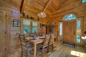 a dining room with a wooden table and chairs at Storybook in Morganton +34 photos