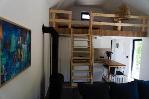 a room with a loft bed and a desk at Udahni prirodu - Panorama in Raška