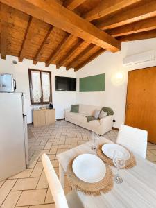a living room with a table and a couch at Moniga Castle Apartment in Moniga