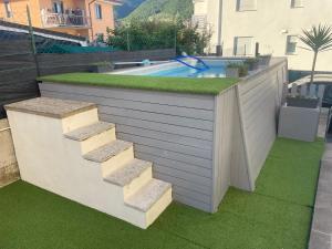 a retaining wall with stairs leading to a swimming pool at ABC Holiday in Salò