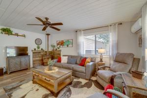 a living room with a couch and a ceiling fan at Payson Summer Getaway w/ Backyard in Payson