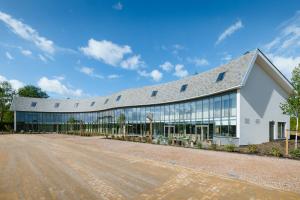 a large white building with a lot of windows at Hotel Riet I Kloeg Collection in Koudekerke