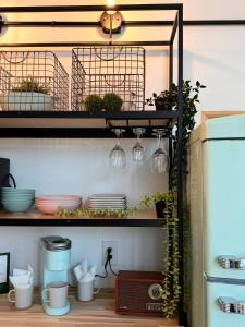 a shelf with dishes and plants on it at Treeangle Treehouse in Morganton