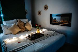 a bedroom with a bed with lights on it at L'Envol - Jacuzzi, Sauna et belle vue in Cherbourg en Cotentin