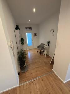 a hallway with a table and a chair in a room at KC Appartments in Schwanau