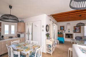 a kitchen and a dining room with a table and chairs at Popis Home in Faros +7 photos