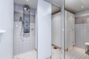 a bathroom with a shower stall and a toilet at City Hostel in Stockholm