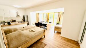 a room with two beds and a kitchen and a living room at Aparthotel Grünewald in Hannover
