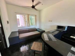 a living room with a couch and a table at Hotel Aqualuna Departamento #aussiepipe in Puerto Escondido +9 photos