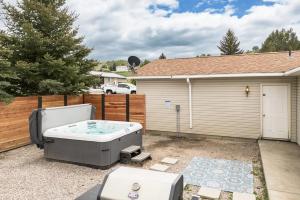 a hot tub in the backyard of a house at Library INN - Boutique Rooms - Free Breakfast - Hot Tub in Lava Hot Springs