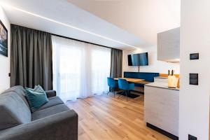 a living room with a couch and a table at AurAlpin Apartments in Cadipietra