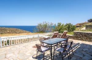a patio with a table and chairs and the ocean at Popis Home in Faros