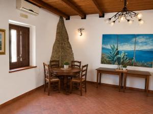 a dining room with a table and chairs at Borgo Luce - Rooftop and Rooms in Francavilla Marittima