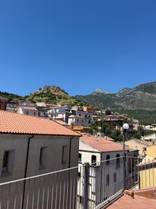 a view of a city with houses and mountains at Borgo Luce - Rooftop and Rooms in Francavilla Marittima