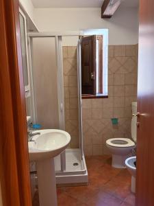 a bathroom with a sink and a toilet at Borgo Luce - Rooftop and Rooms in Francavilla Marittima +14 photos