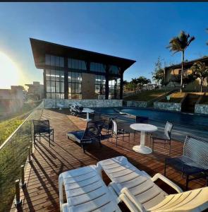 a patio with chairs and a swimming pool at A casa do vale in Bananeiras