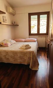 a bedroom with a large bed with two windows at Il Nido di Zia Mina in Formia